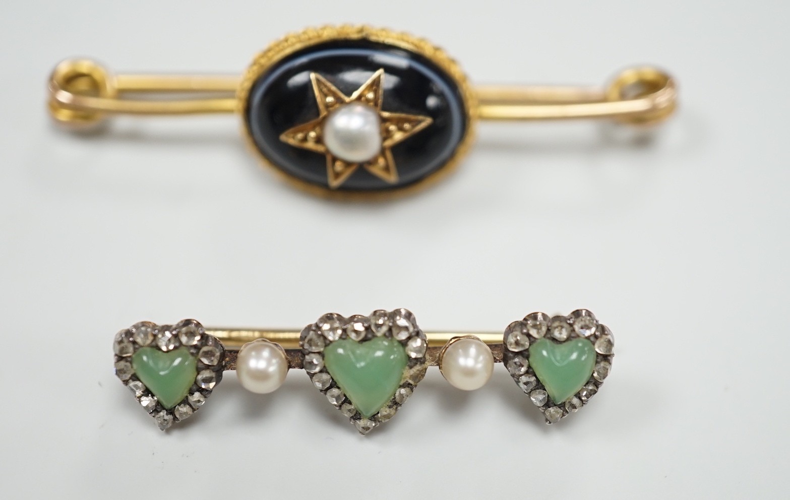An early 20th century Austro-Hungarian? yellow metal, chrysoprase, rose cut diamond and seed pearl, set triple heart motif bar brooch, 32mm and a Victorian banded agate and split pearl set bar brooch